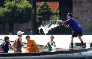 On a searing mid-summer’s day, young boys seek relief from the heat in the public fountain in Republic Square in downtown Yerevan.