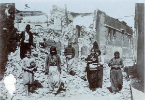 Armenian survivors of the massacres at the ruins of their houses 