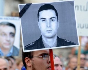 A protester holds the picture of Lt. Gurgen Margaryan on the 9th anniversary of his brutal murder. (Photo: Yerkir Media)