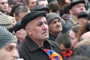 A man listens to Hovannisian during the rally at Freedom Square in Yerevan on Feb. 28. (photo by Khatchig Mouradian, The Armenian Weekly)