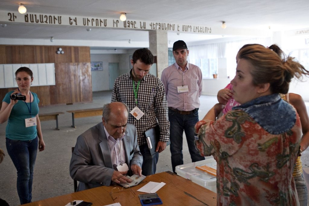 Diasporan Matt Ghazarian and his partner Mariam Dilbandyan watch and document the voter registration process. 