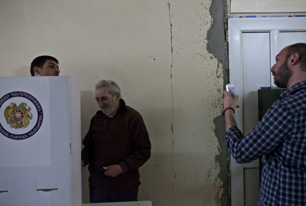 Diasporan repatriate Babken Der Grigorian documents two people approaching the voting booth together. 