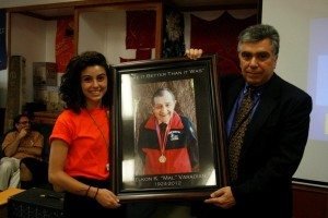 Michael Varadian presents a photograph of his noted dad Malcolm to head counselor Arev Dinkjian for permanent display at Camp Haiastan.