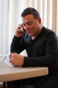 Fashion designer Samuel Vartan made phonecalls from the Koutoujian campaign’s office in Watertown. (Photo by Nanore Barsoumian)