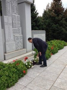 Demirbaş placing flowers at the Armenian Genocide Memorial in Providence