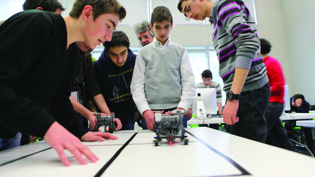 Students experiment in robotics during a workshop.