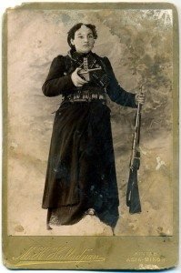 Image of the postcard found in the wall of an Armenian home in Ayntap: Heghine, the widow of Kevork Chavoush, with Mauser handgun in her right hand and a shortened-barrel (or stage prop) Mosin rifle in her left