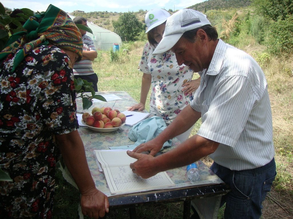 Slavik Zurnachyan works together with fellow farmers in Haghtanak to plan their local greenhouse production.