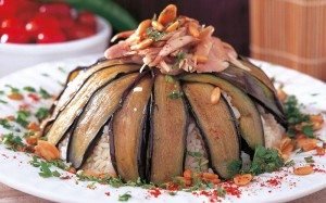 Makloube—consisting of meat, rice pilaf, and eggplants—is layered and cooked then served upside down.