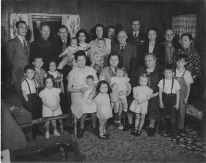 Mary's adoptive family, Letts-Harris, Thanksgiving, 1948. Mary is in the bottom row on far left, in the white bow, dress, and shoes. (Eaton Rapids, Mich.) 