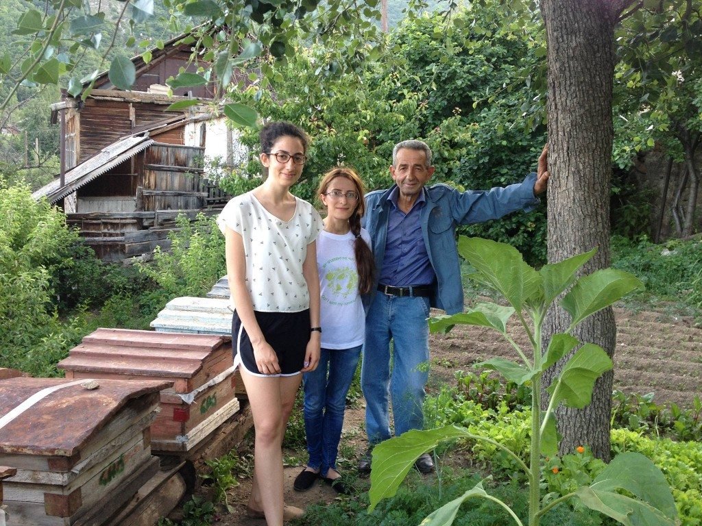 Bard College student Lia Soorenian distributes beehives to families in the rural community of Lichk, Armenia.