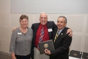 Armen Harootian, center, is inducted into the Fitchburg State University Athletic Hall-of-Fame for the second time, joining the charmed circle in both track and soccer. Sharing in the celebration are Sue Lauder, athletic director, and Dr. Robert Antonucci, university president.