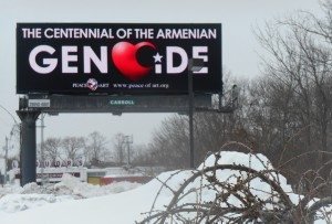 Against a black background, one billboard reads, "1915-2015 the Centennial of the Armenian Genocide." 