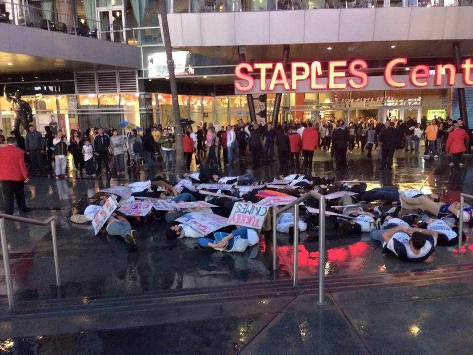 Despite the rain, demonstrators collapsed to the ground in the sudden-death act, as thousands of people exited the Staples Center following a Los Angeles Lakers game. 