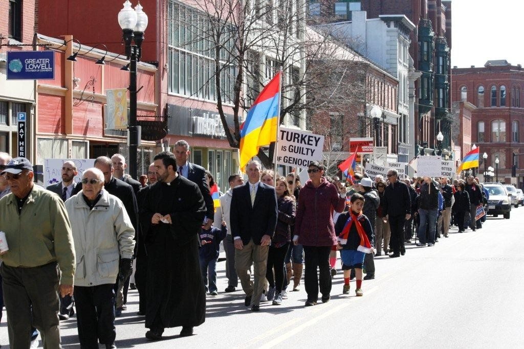 Dozens gather in a procession along Merrimack Street in Lowell during the Centennial commemoration April 25. (Photo: Tom Vartabedian)