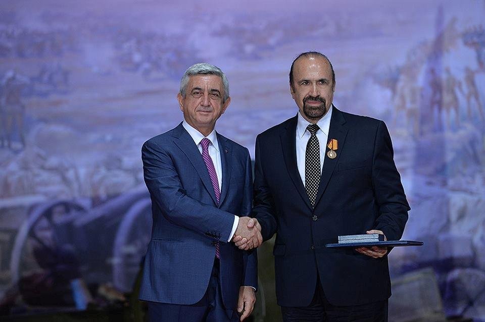 Chelmsford artist Daniel Varoujan Hejinian (right) receives the prestigious Medal of Movses Khorenatsi from Armenian President Serge Sarkisian.