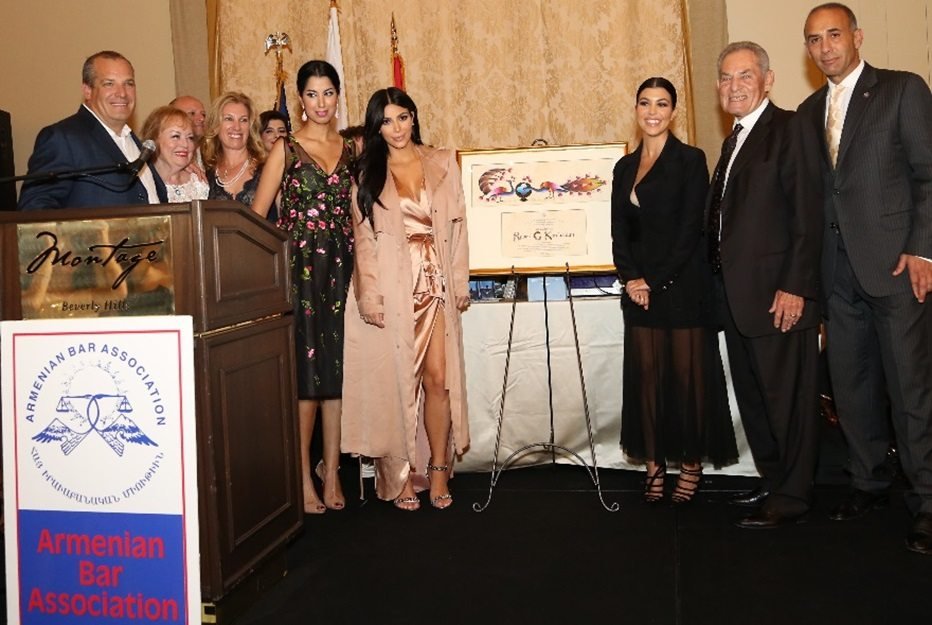 Kim and Kourtney Kardashian flanked by Tina Odjaghian, uncle Tommy Kardashian, Armen Hovannisian, and members of the Kardashian family.