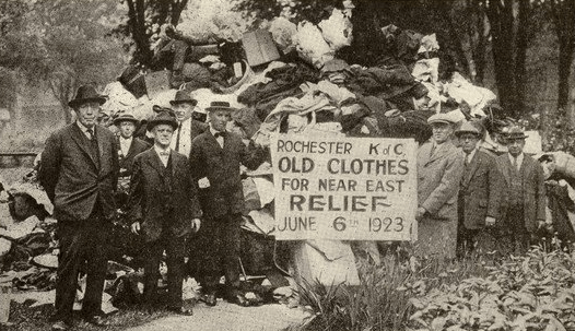 Knights of Columbus of Rochester, N.Y. collect a 'mountain of clothes' for Near East Relief in 1923