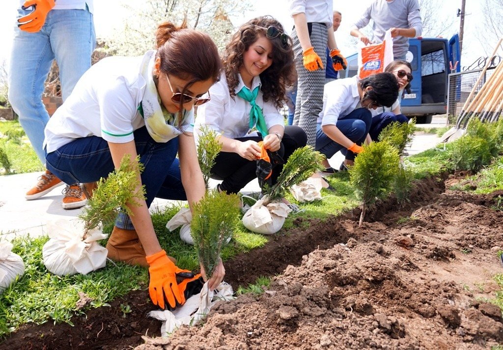 Employees from ACBA Credit Agricole Bank plant trees with ATP on the grounds of St. Karapet Church in Akunk Village