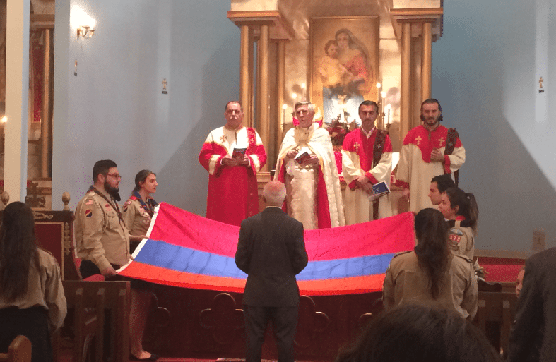 Godfather of the flag, Murad A. Meneshian, during blessing of the flag church service