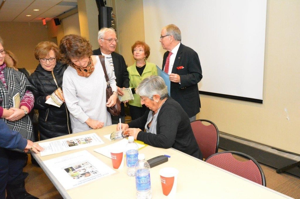Cetin signs copies of her books following the N.J. event