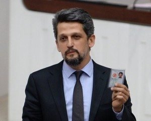 Garo Paylan holds up his identification card during a speech in Parliament on Jan. 13. (Photo: Ermenihaber.am)