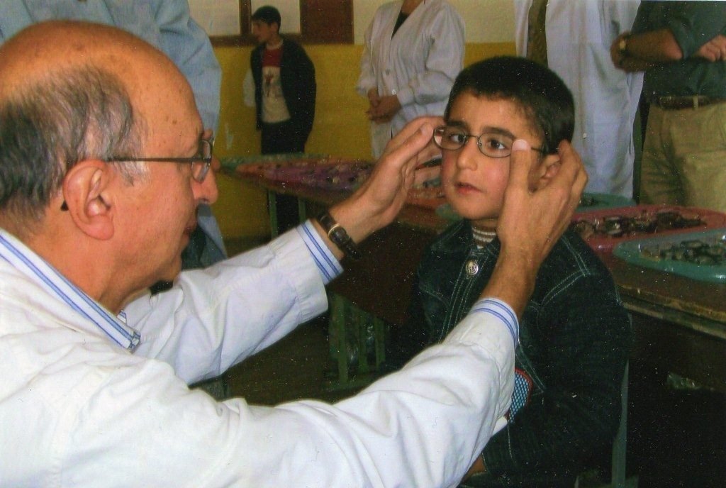  Optometrist Dr. James Fantazian helps a young Armenian boy see correctly during one of two missions he made to Hayasdan.