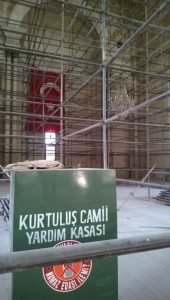 A Turkish flag, hung in order to cover up the cross in the background