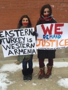 Two students at Grand Valley State University hold signs demanding justice