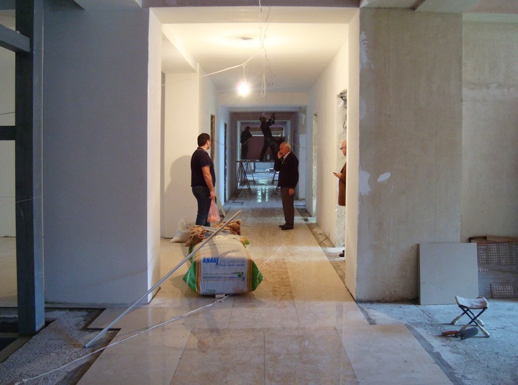 Workers completing interior finishing of flooring and walls (November 2015, Yerevan)