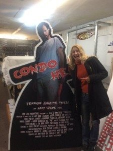 Amy (Harootian) Wade stands by a billboard promoting her new film ‘Condo Hell’, which premiered in Rhode Island and is headed for the Hollywood Reel Independent Film Festival in California.