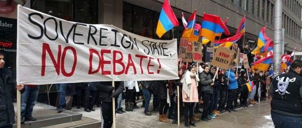Protesters held a banner that read, "Soverign State, No Debate!" (photo: AYF Canada)