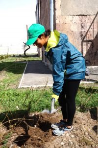 Volunteer Natalie Shahbol planting her first tree with ATP at Yerevan’s Pokr Mher Military Educational Complex