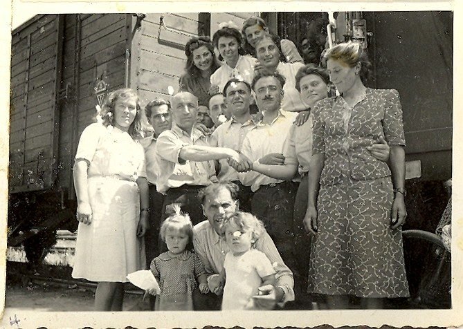 Armenian DPs with wives and children in the Klagenfurt DP camp. My father in the front bottom of photo holding my playmate and I; my mother at the very top.