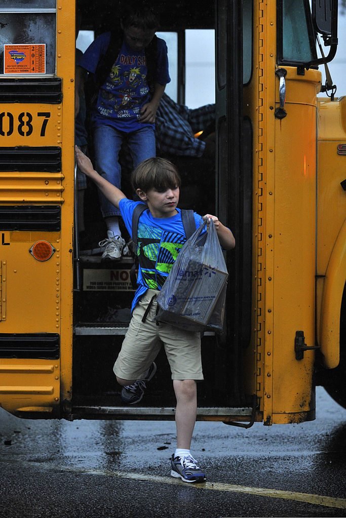  A child steps off a school bus on the first day of school at Shaw Heights Elementary School on Shaw Air Force Base (Photo: Jensen Stidham)