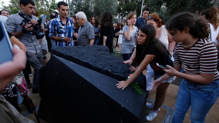 Melani Nazarian, left, and Ashley Muradian view the first permanent monument in L.A. to memorialize the Armenian Genocide after it was unveiled at Grand Park. (Glenn Koenig / Los Angeles Times)