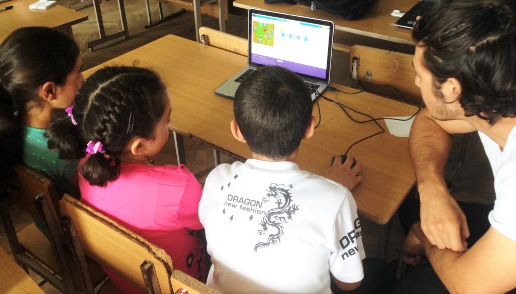 The Luys Scholar is helping the children to create their first animation project.